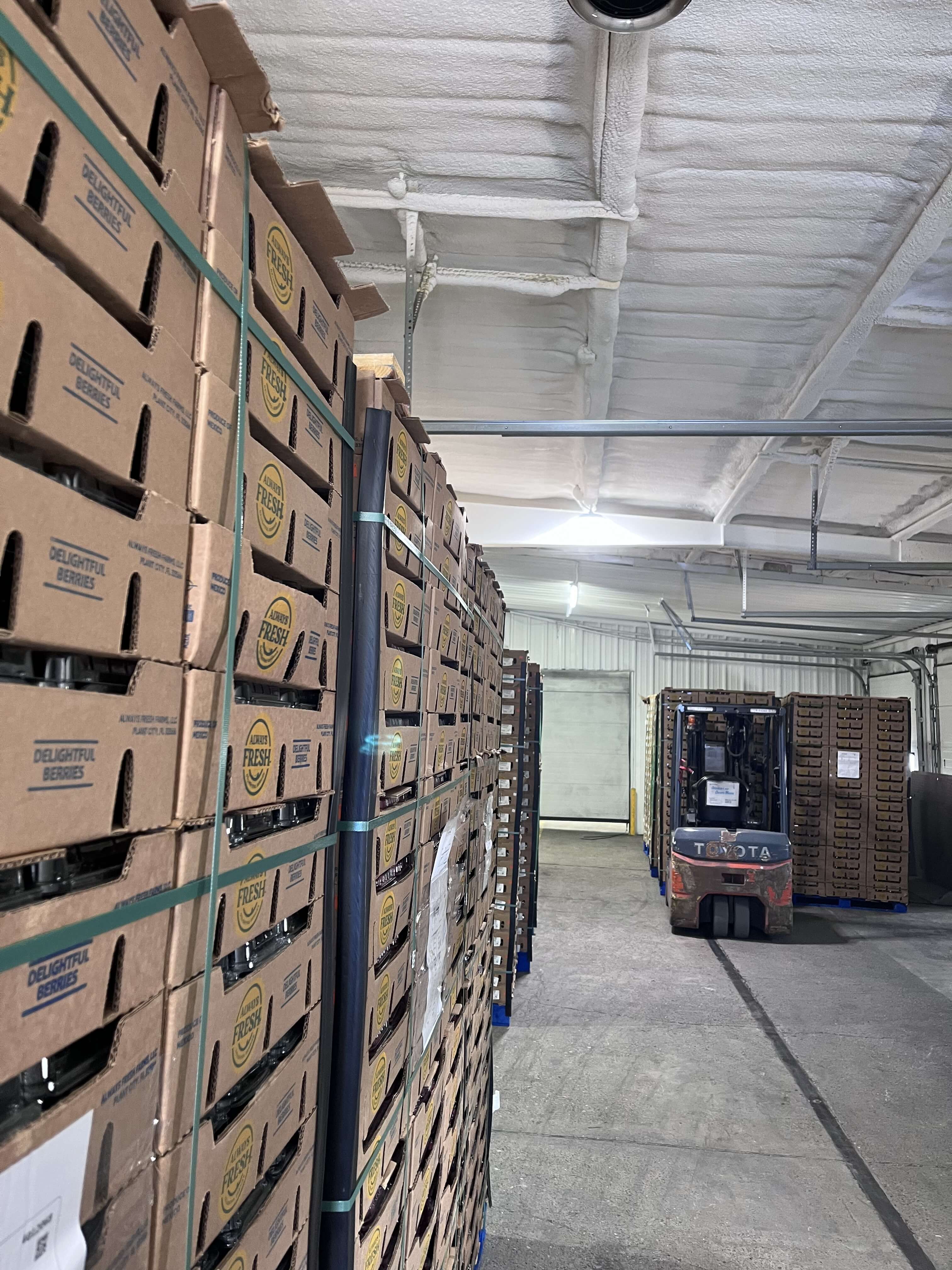 INCO cold storage interior with produce pallets and forklift